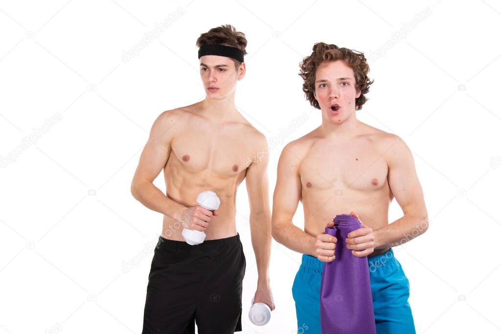 Fitness and healthy lifestyle. Two young attractive students in the gym. White background.