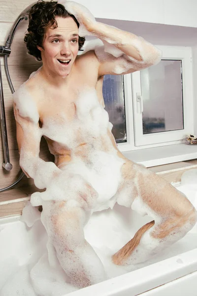 Joven Chico Atractivo Está Descansando Una Bañera Con Espuma — Foto de Stock
