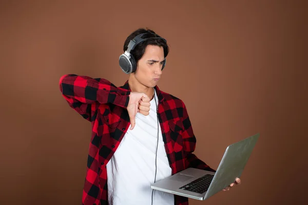 Handsome guy listens to music with headphones.
