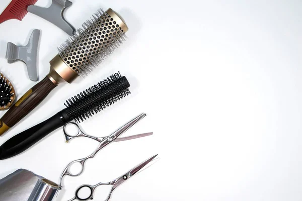 Hairdressing industry. Professional hairdressing tools. Comb, scissor, clippers and hair trimmer isolated on white background Royalty Free Stock Images