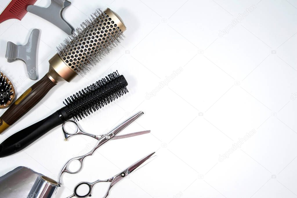 Hairdressing industry. Professional hairdressing tools. Comb, scissor, clippers and hair trimmer isolated on white background