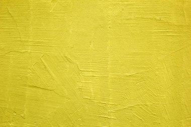 Duvarların sarı dokusu. Parlak, sıcak, sarı bir arka plan. Alçılı eski bir duvar.