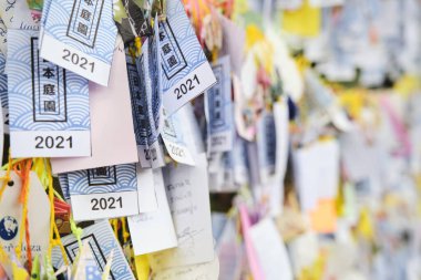 Buenos Aires, Argentina, March 17, 2021: Many strips of paper with wishes written on them, hung in the Japanese garden, following an Asian tradition. clipart