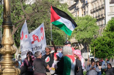 Buenos Aires, Argentina; October 7, 2025: massive protest in support of Palestine marking two years since the intensification of the Israeli Zionist genocide in Gaza. Man raising a Palestinian flag.