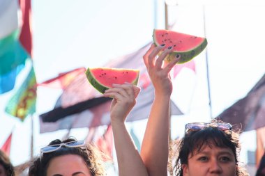 Buenos Aires, Argentina; October 7, 2025: massive protest in support of Palestine, against the Israeli Zionist genocide in Gaza. Protesters hold up pieces of watermelon, a Palestinian symbol
