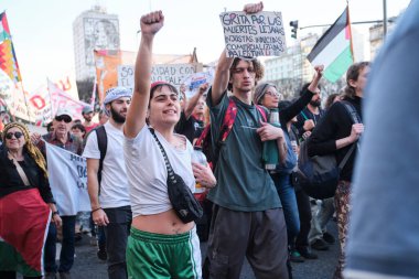 Buenos Aires, Argentina; October 7, 2025: massive protest in support of Palestinian people. Sign: Cry out for the distant, unjust, induced, commercialized deaths. Free Palestine!