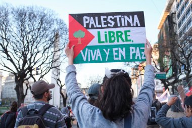 Buenos Aires, Argentina; October 7, 2025: massive protest in support of Palestine against the Israeli Zionist genocide in Gaza. Flag message: Free Palestine, alive and at peace.