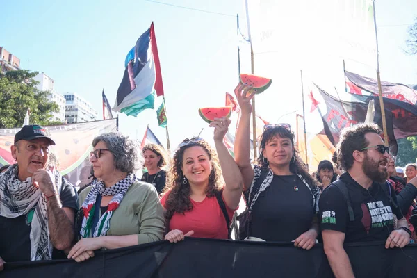 Buenos Aires, Argentina; October 7, 2025: massive protest in support of Palestine, against the Israeli Zionist genocide in Gaza. Protesters hold up pieces of watermelon, a Palestinian symbol