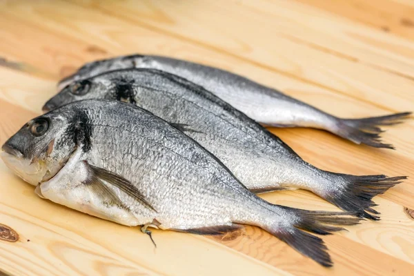 Fish on wooden background — Stock Photo, Image