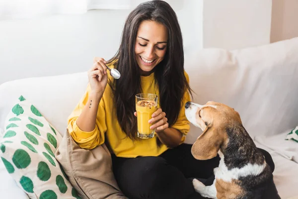beautiful young woman drink a smoothie with her dog