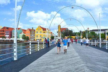 Willemstad, Curacao - March 27, 2017: Pontoon bridge and waterfront with harbour and colorful houses in Willemstad, Caribbean. The city center is UNESCO World Heritage Site.