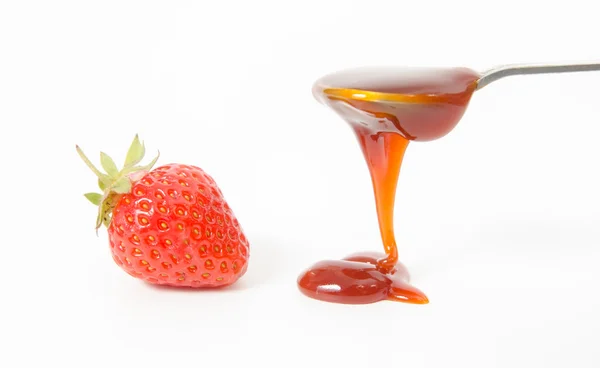 Strawberry and spoon with red jam