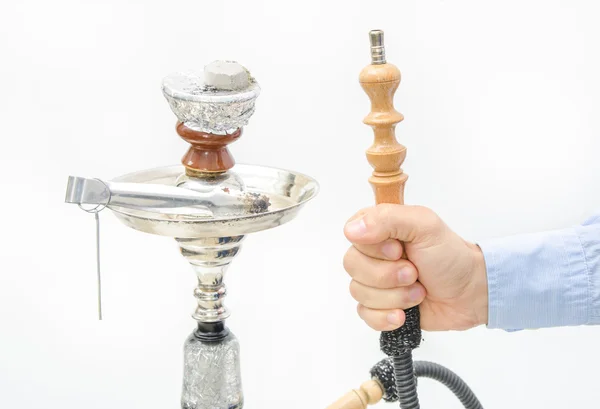 Hookah with coal and hose in a man's hand