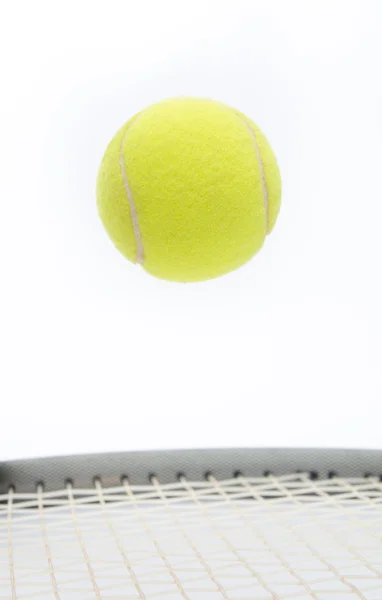 Tennis ball on racket — Stock Photo, Image