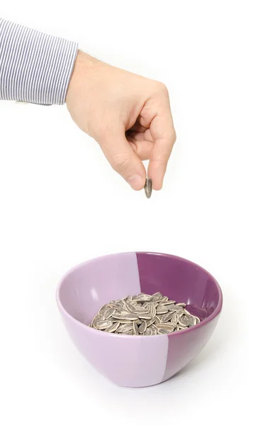 Sunflower seeds in a bowl on a white background — Stock Photo, Image