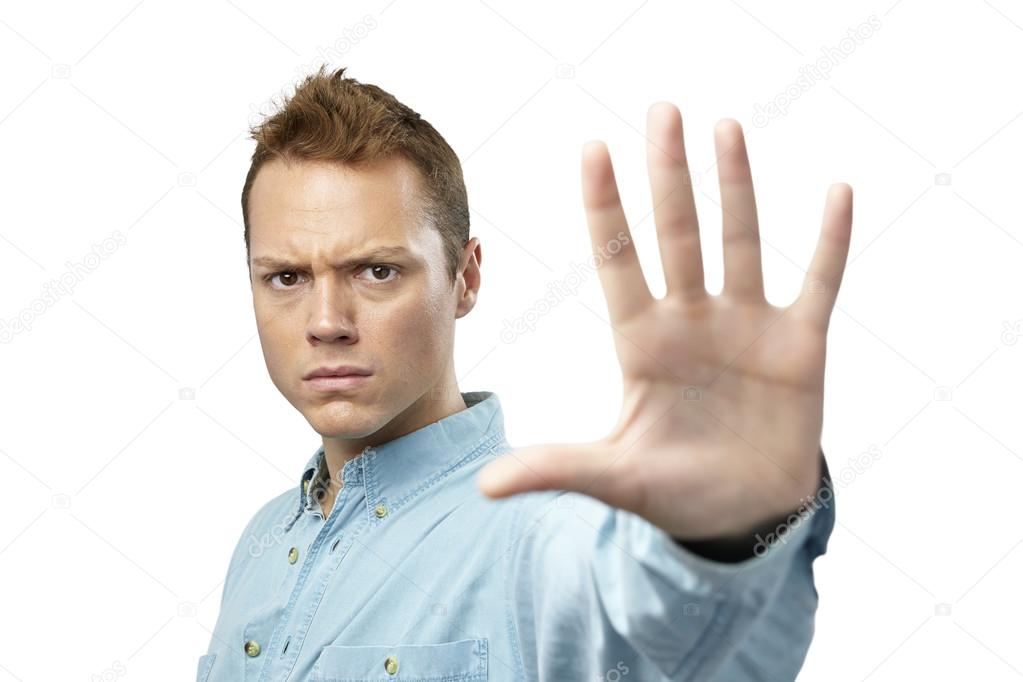 Young man giving hand stop sign