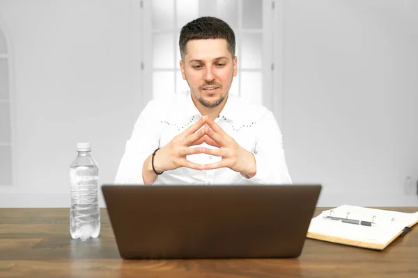 Manager working on a project in open space office. Paperwork and laptop on the table — Stock Photo, Image