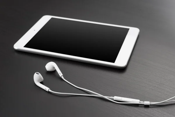 Digital tablet and headphones — Stock Photo, Image