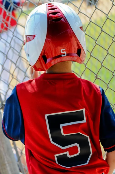 Little league baseball boy in dugout. — Stock Photo, Image