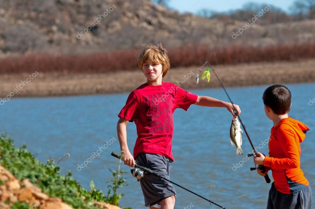 Two boys on catching a fish. Stock Photo by ©tammykayphoto 106640668