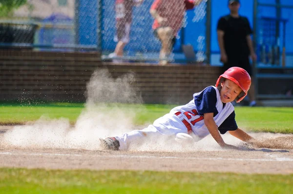 Baseball player sliding into home plate — Stock Photo, Image