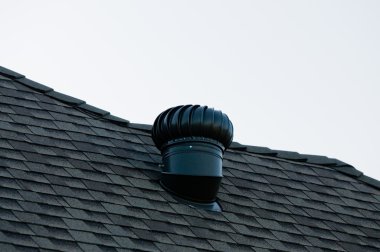 Exhaust vent on top of a roof. clipart