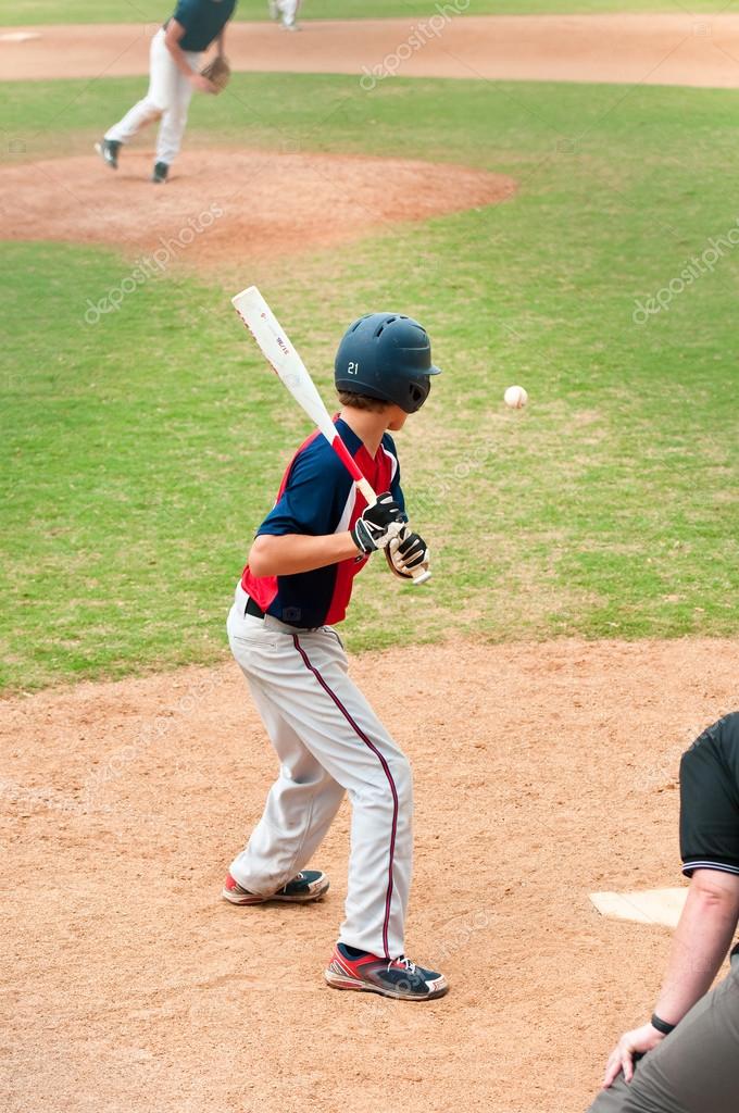 Teen player watching baseball at bat ⬇ Stock Photo, Image