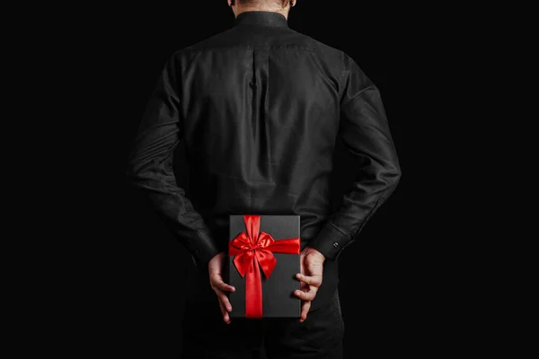 Man Black Shirt Holds Gift Red Ribbon His Back Black — Stock Photo, Image