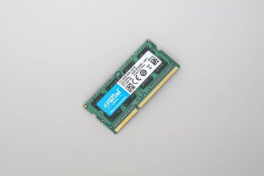 Mavi etiketli yeşil bir DDDR3 SODIMM RAM modülünün yakın çekimi, beyaz arkaplanda izole edilmiş.