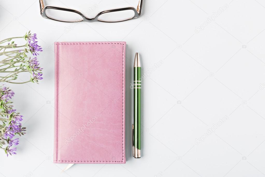 closed notebook with pen