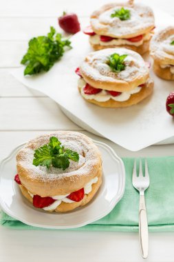 Ev yapımı pasta yüzük krem peynir ve çilek ile dekore edilmiş nane yaprakları