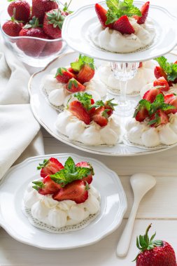 Mascarpone krema ve taze nane yaprakları ile ev yapımı küçük çilek pavlova beze pasta 