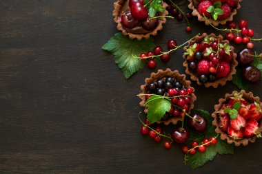 Çikolatalı Krema, taze çilek, ahududu, yaban mersini, kırmızı kuş üzümü ve kiraz çikolata tartlets, yakın çekim 