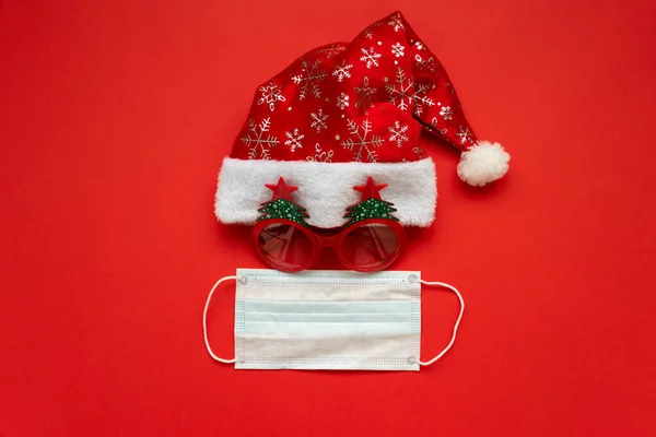 Santa Claus Hat Glasses Face Mask Red Background Flat Lay — Stock Photo, Image