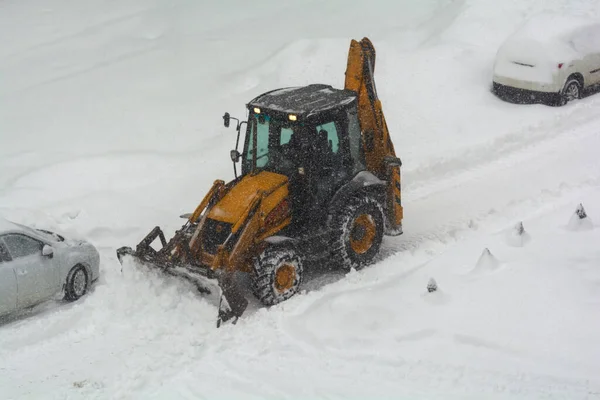 Clearing the road from snow. February snowfall