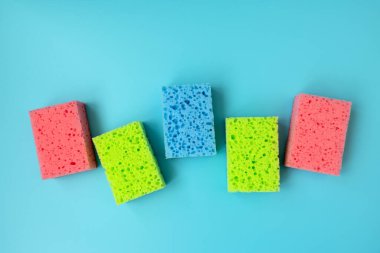 Kitchen cleaning set of sponges on blue background. Top view