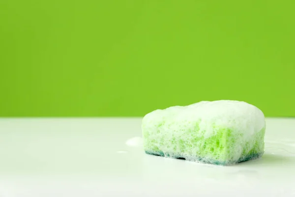 Green Kitchen Cleaning Sponge Soap Bubbles Lying White Background Front — Stock Photo, Image