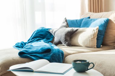 Yastıklı Şenlikli Oturma Odası, Mavi Battaniye, Kupa ve Açık Kitap