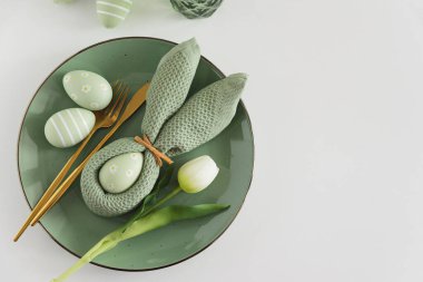 Tavşan peçetesi, süslü yumurta ve lalelerle Paskalya Sofrası. Şenlikli Bahar Düzenlemesi