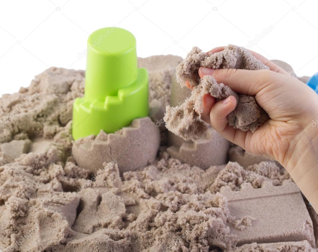 Fun kinetic sand.Child building sand castle 