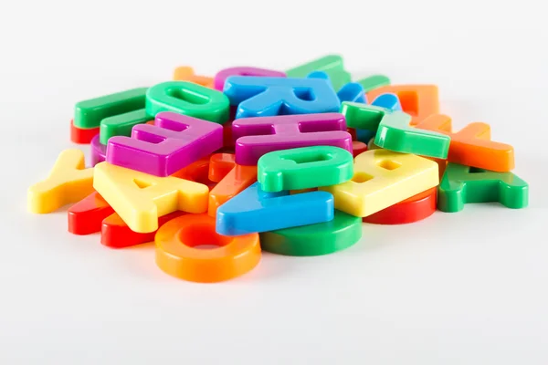 Colorful plastic alphabet letters on white background — Stock Photo, Image