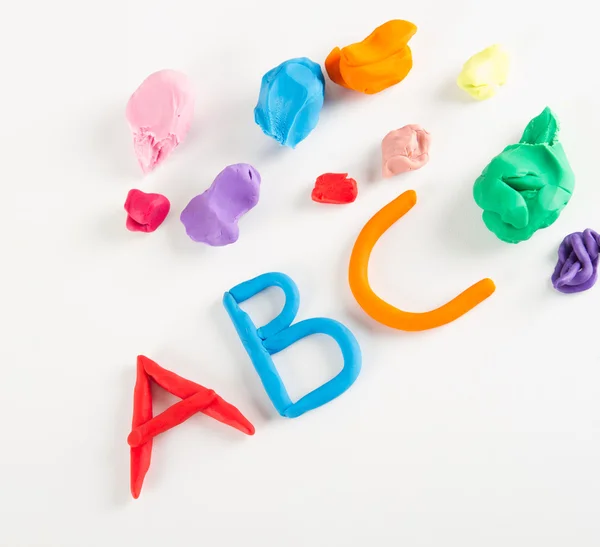 Colorful plasticine letters on white — Stock Photo, Image