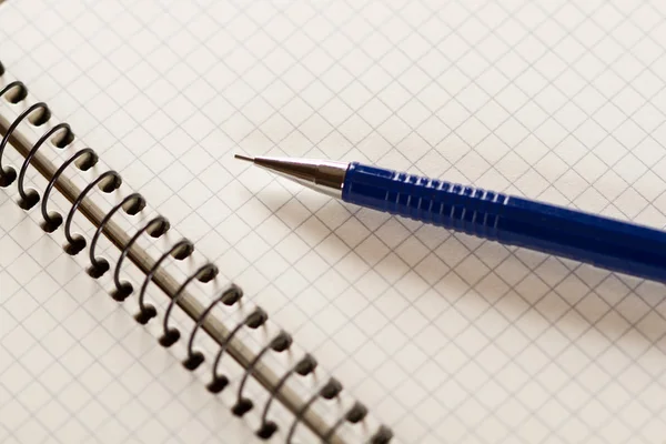 Notebook with a grid and pen — Stock Photo, Image