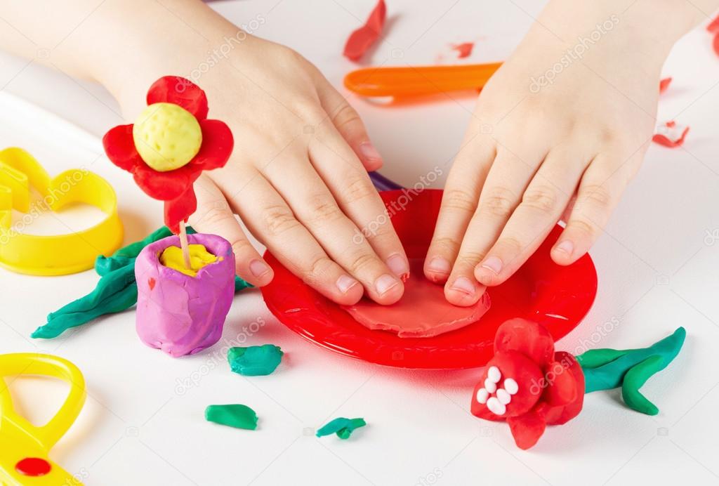 Child hands  with colorful clay