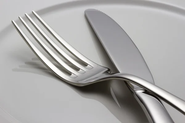 Cutlery on a plate — Stock Photo, Image