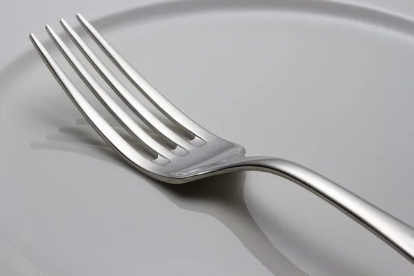 Fork on a plate — Stock Photo, Image