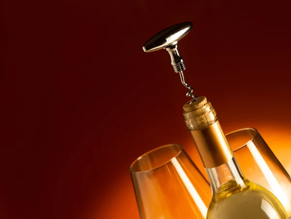 White wine bottle with corkscrew — Stock Photo, Image
