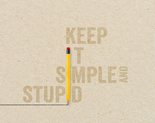 KISS Concept - Keep it simple and stupid with yellow pencils on brown paper and chalkboard background