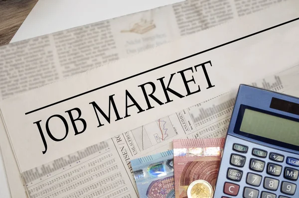 Newspaper with job market with money and calculator