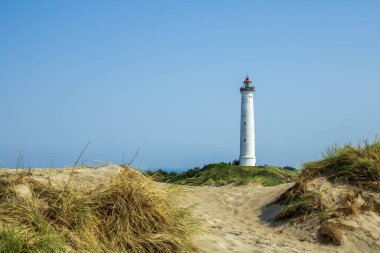 Different vacation impressions from denmark west coast with lighthouse, boats, dunes, footpath, windmills